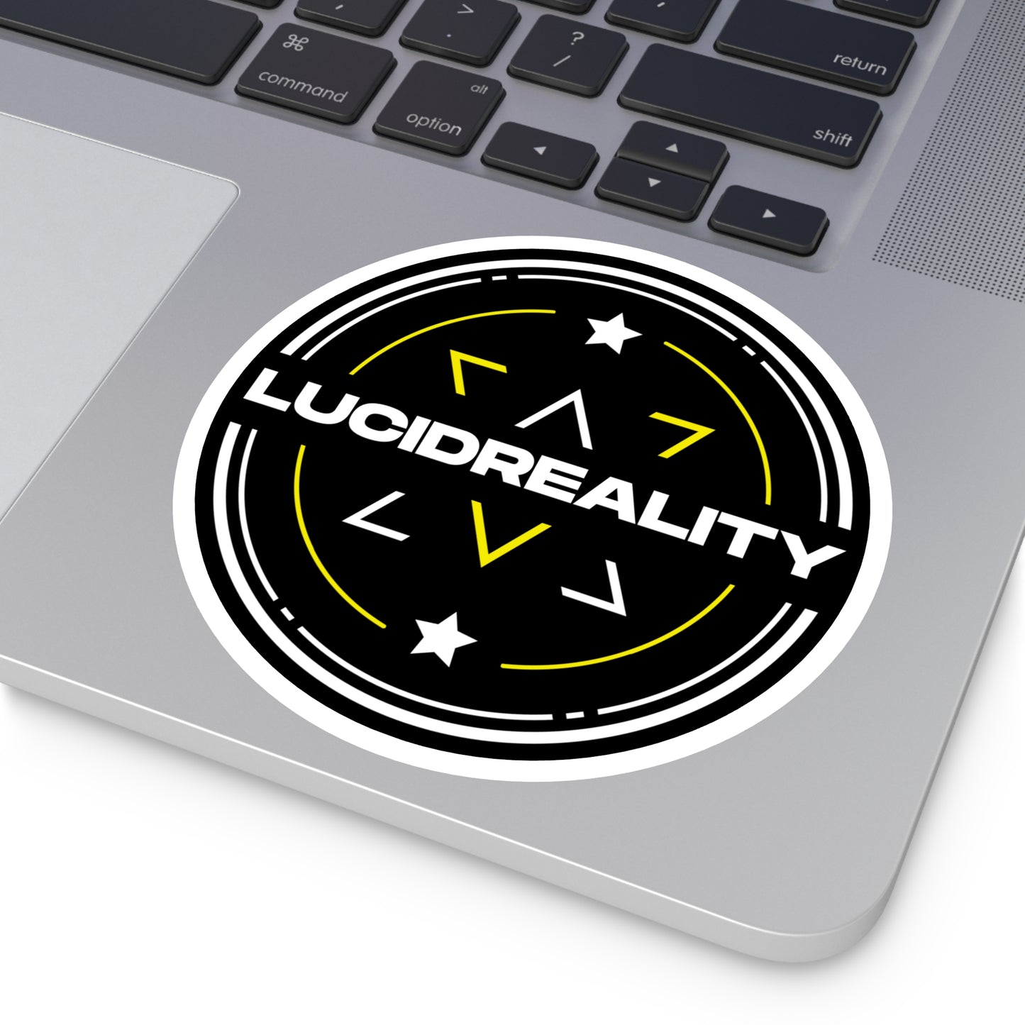Lucid Reality circular logo sticker placed on a laptop surface.