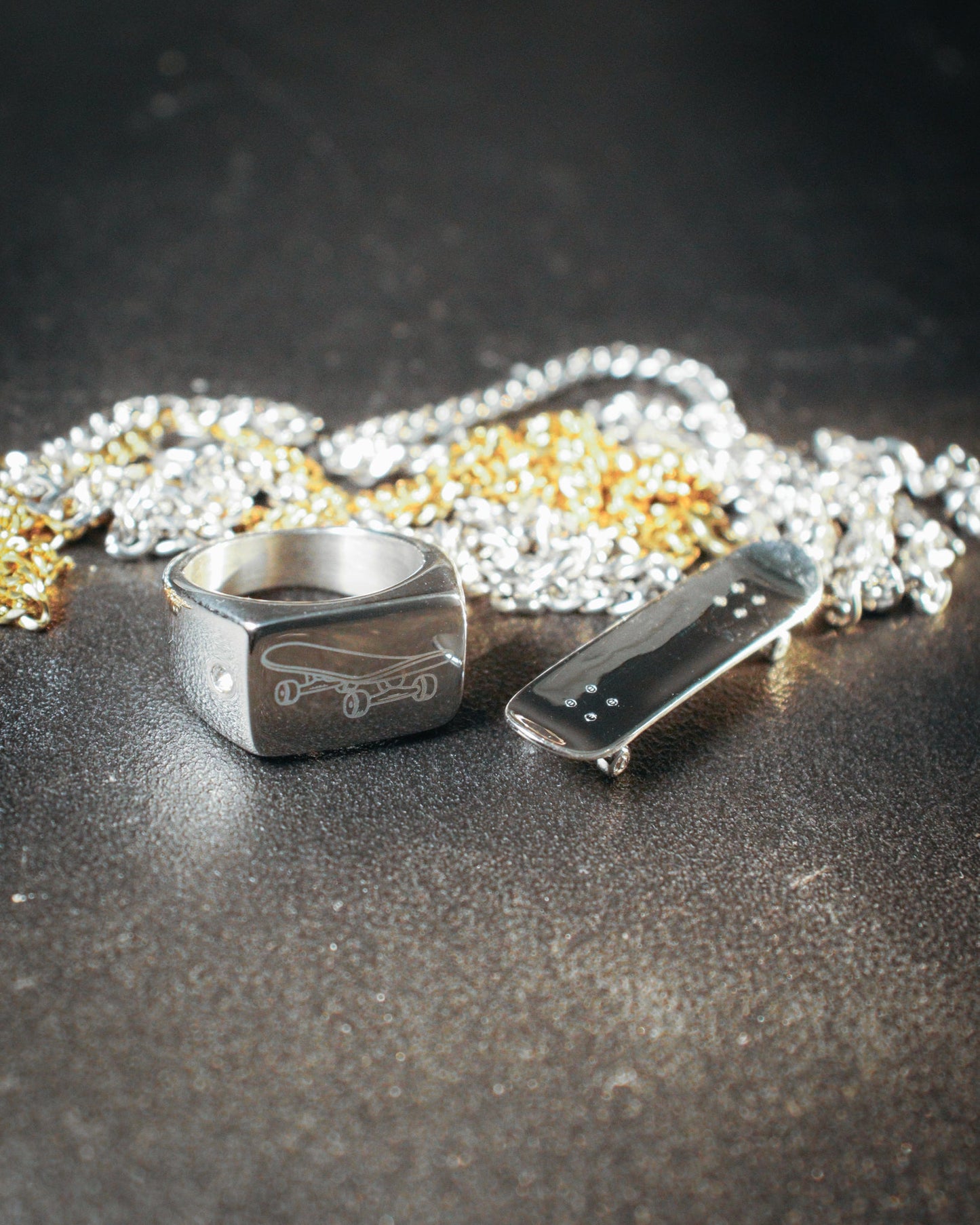 Sterling silver skateboard deck pendant with matching ring, curated by Lucid Reality