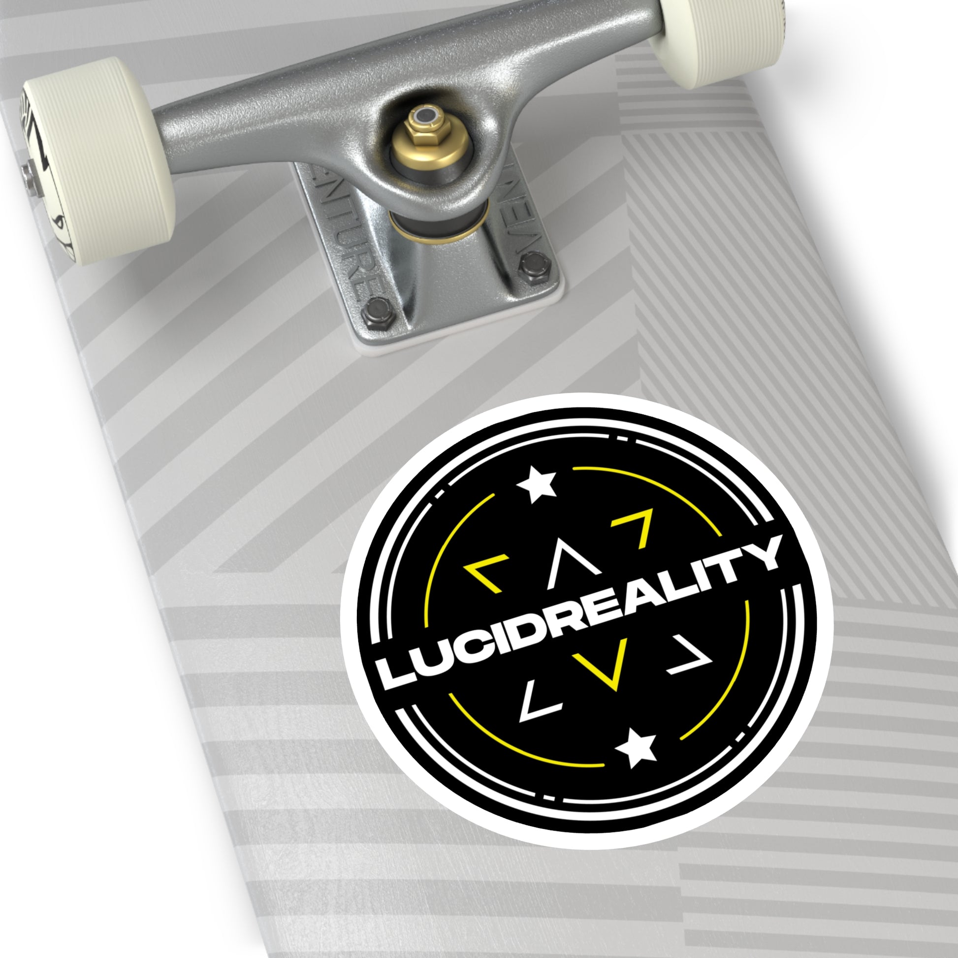 Close-up of the round Lucid Reality logo sticker on a skateboard surface.