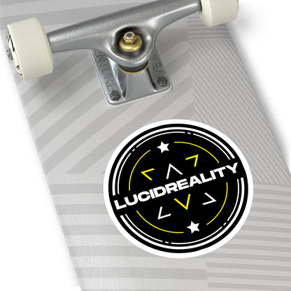 Close-up of the round Lucid Reality logo sticker on a skateboard surface.