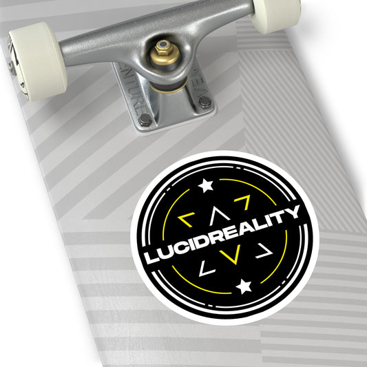 Close-up of the round Lucid Reality logo sticker on a skateboard surface.