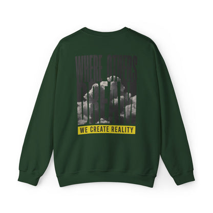 Back of the forest green Where Others Dream Crewneck Sweatshirt with the city skyline graphic and yellow We Create Reality banner.