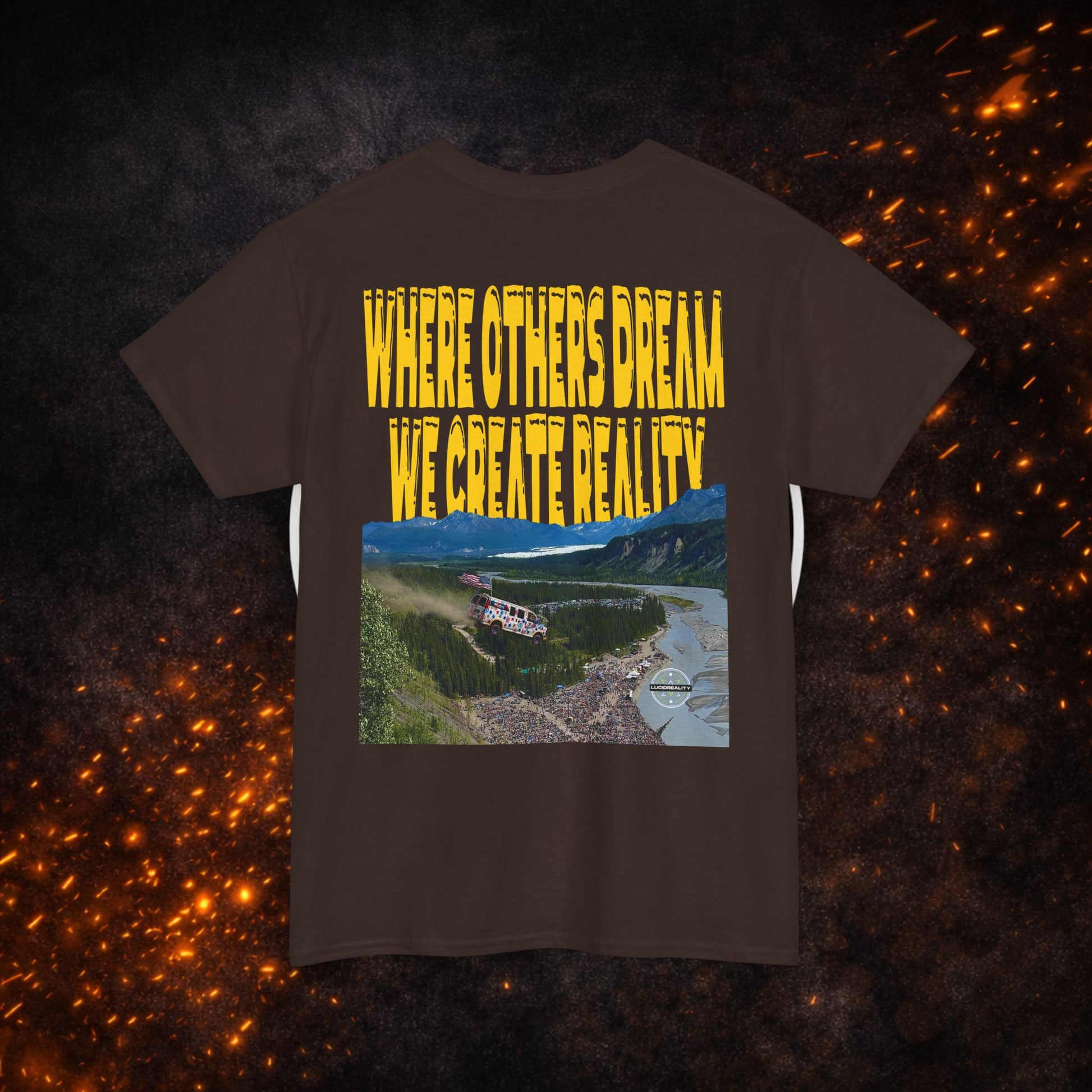 Back view of the brown Lucid Reality Where Others Dream Tee showing the "Where Others Dream We Create Reality" yellow text above a mountain and river landscape graphic.