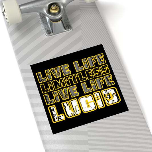 Close-up of black Lucid Reality sticker with gold "LIVE LIFE LIMITLESS LIVE LIFE LUCID" text design on a skateboard.