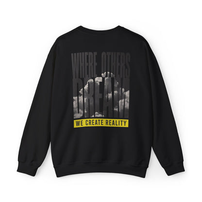 Back of the black Where Others Dream Crewneck Sweatshirt with the city skyline graphic and yellow We Create Reality banner.
