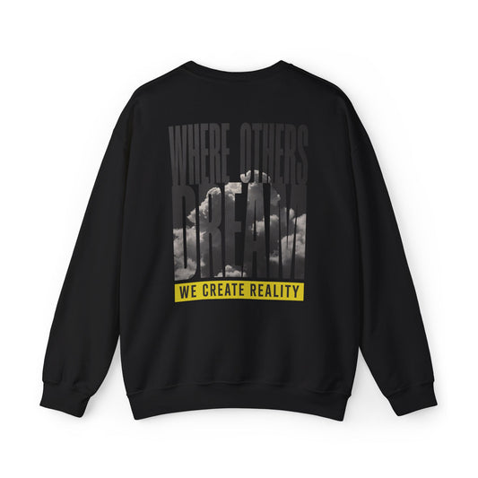 Back of the black Where Others Dream Crewneck Sweatshirt with the city skyline graphic and yellow We Create Reality banner.