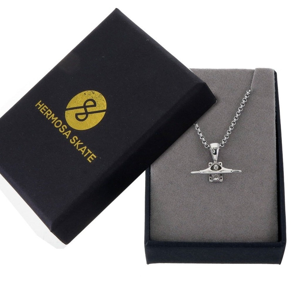 Sterling silver skateboard truck pendant on a Cuban chain, curated by Lucid Reality