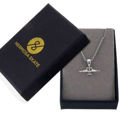 Sterling silver skateboard truck pendant on a Cuban chain, curated by Lucid Reality