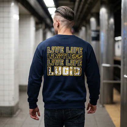 Man wearing the navy blue Lucid Reality "Live Life Limitless Live Life Lucid" Crewneck Sweatshirt in a subway station, showing the gold lettering on the back.