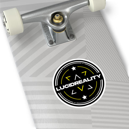 Round Lucid Reality logo sticker applied to the bottom of a skateboard deck, featuring the black circular shield design with white "LUCID REALITY" text.