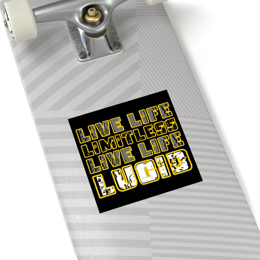 Black square Lucid Reality sticker with gold "LIVE LIFE LIMITLESS LIVE LIFE LUCID" text applied to the bottom of a skateboard deck.