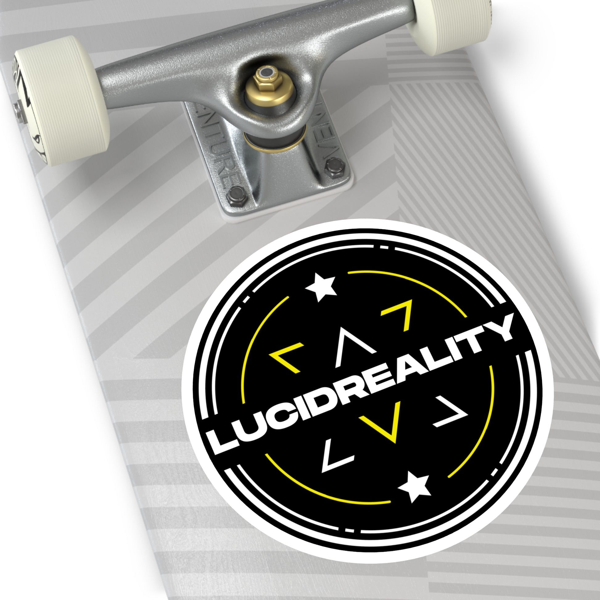 Black circular Lucid Reality logo sticker displayed on a skateboard deck.