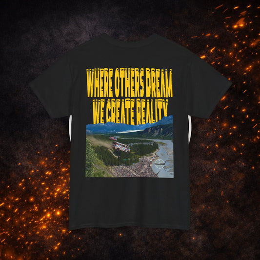 Back view of the black Lucid Reality Where Others Dream Tee showing the "Where Others Dream We Create Reality" yellow text above a mountain and river landscape graphic.