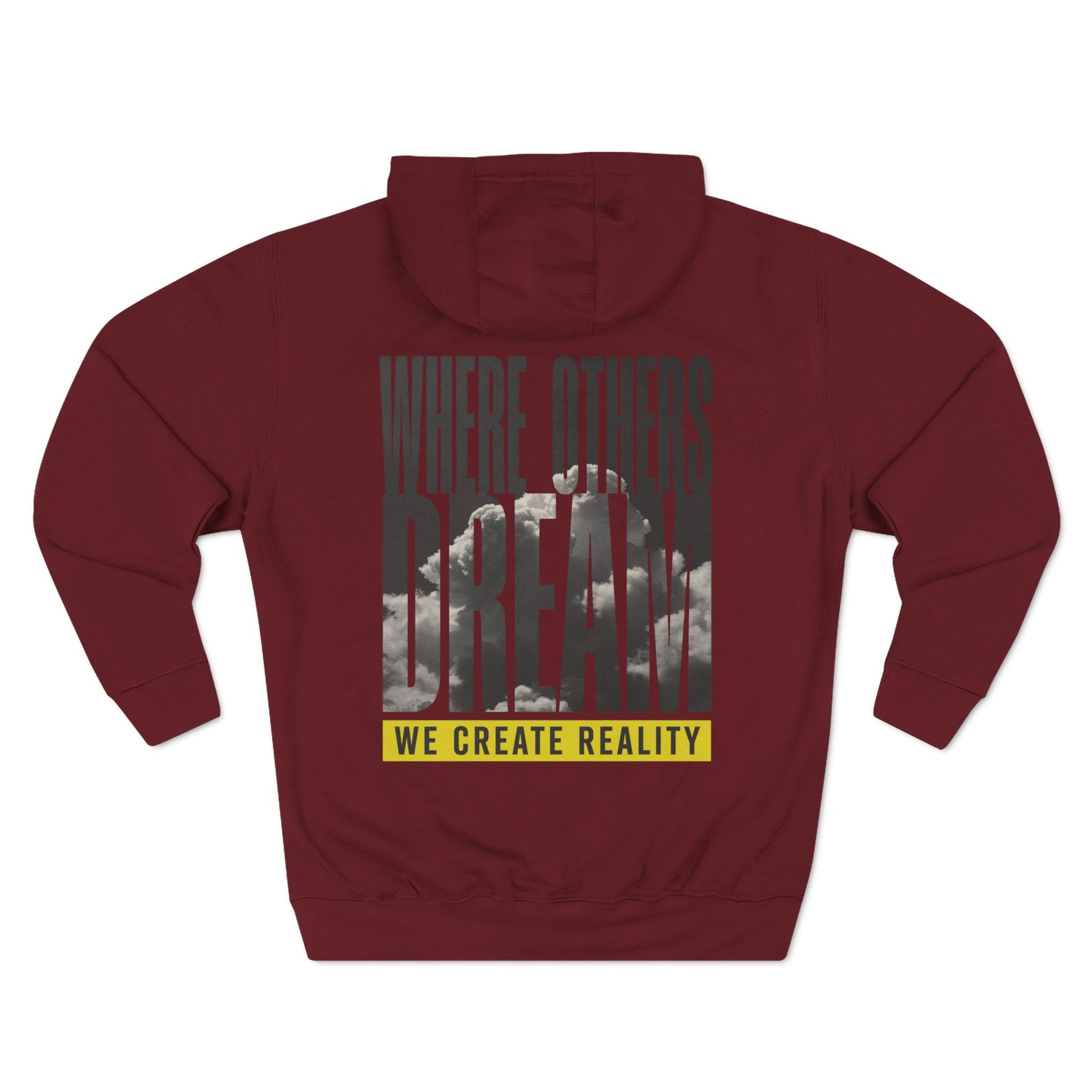 Back of the burgundy Where Others Dream Fleece Pullover Hoodie with the city skyline graphic and yellow We Create Reality banner.