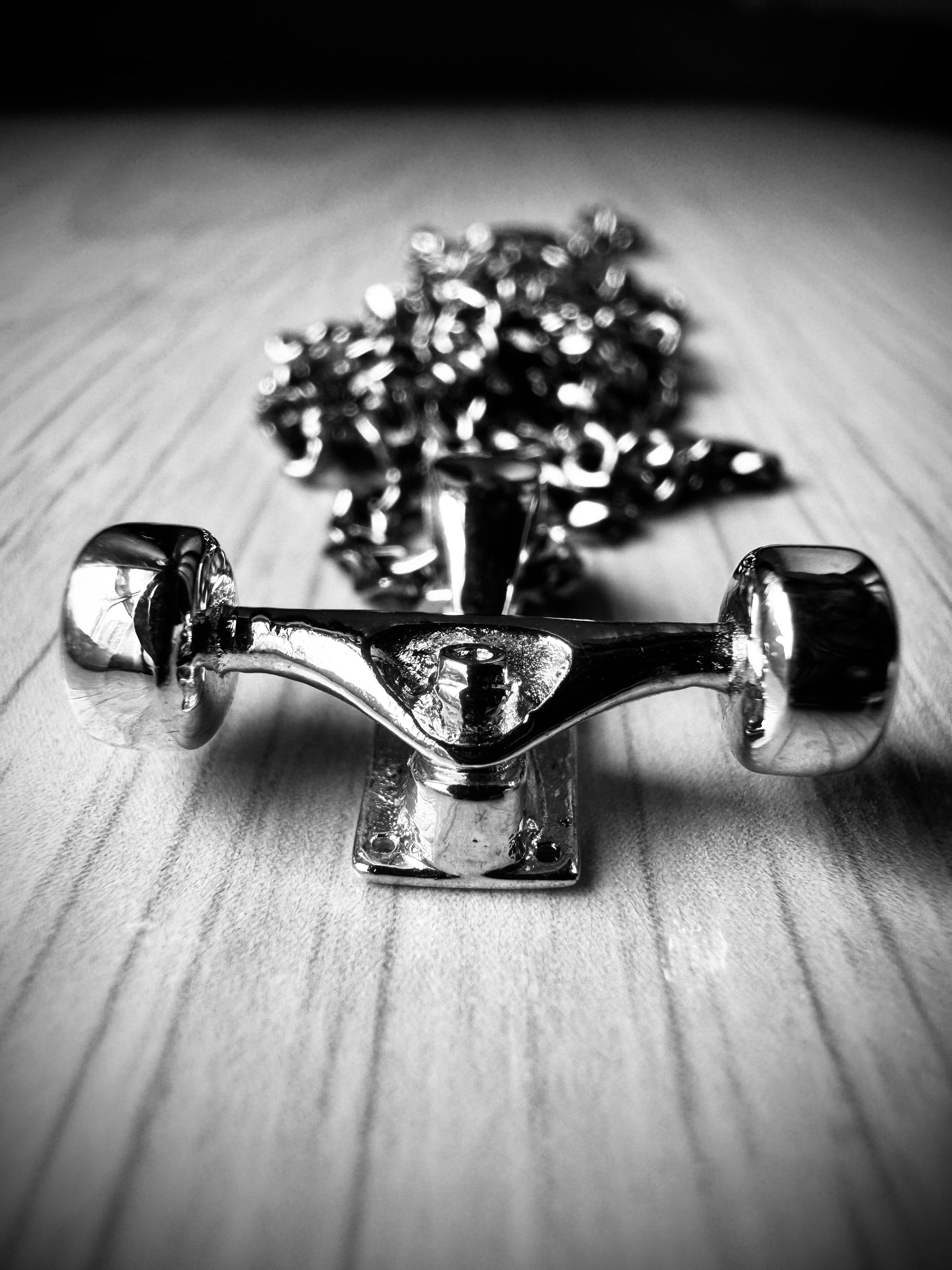 Sterling silver skateboard truck with wheels pendant on a Cuban chain, curated by Lucid Reality