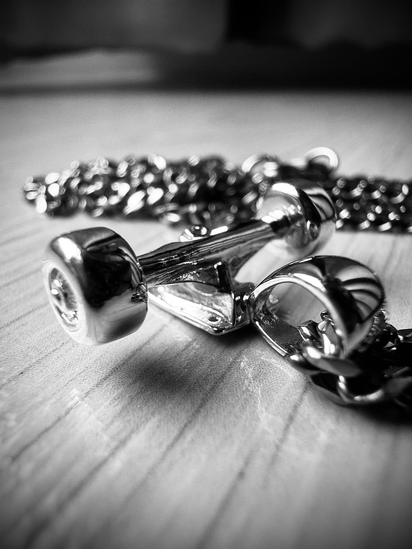 Sterling silver skateboard truck with wheels pendant on a Cuban chain, curated by Lucid Reality