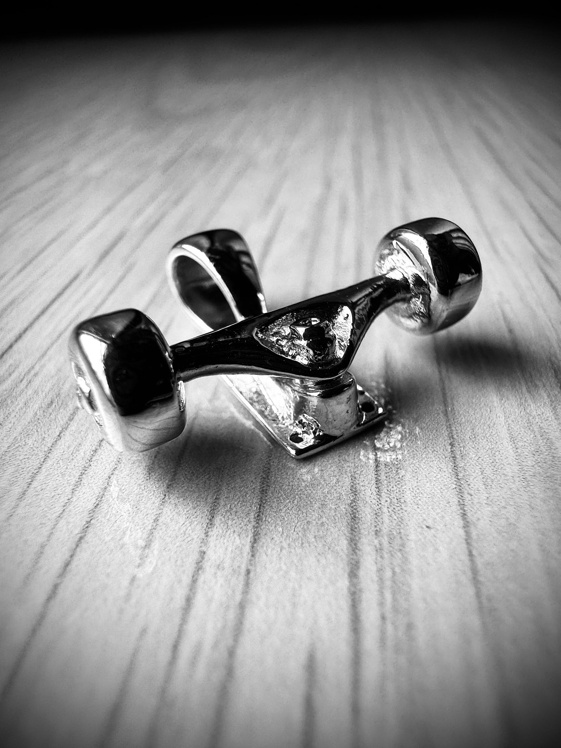 Sterling silver skateboard truck with wheels pendant on a Cuban chain, curated by Lucid Reality