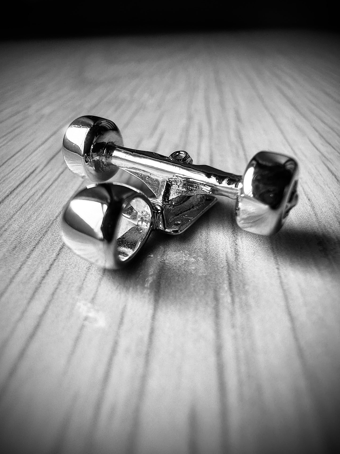 Sterling silver skateboard truck with wheels pendant on a Cuban chain, curated by Lucid Reality