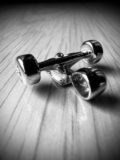 Sterling silver skateboard truck with wheels pendant on a Cuban chain, curated by Lucid Reality