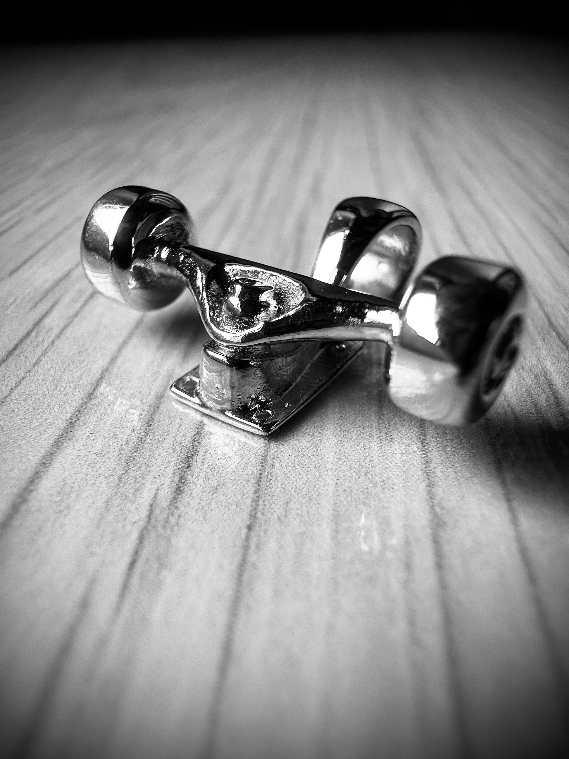 Sterling silver skateboard truck with wheels pendant on a Cuban chain, curated by Lucid Reality