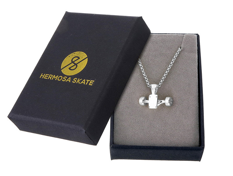 Sterling silver skateboard truck with wheels pendant on a Cuban chain, curated by Lucid Reality