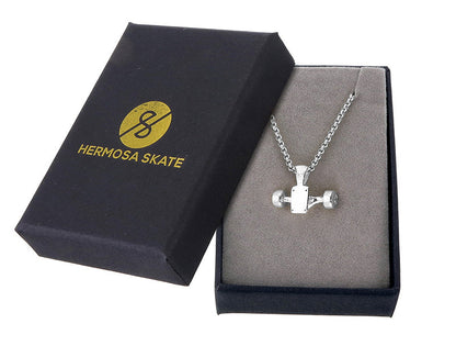 Sterling silver skateboard truck with wheels pendant on a Cuban chain, curated by Lucid Reality