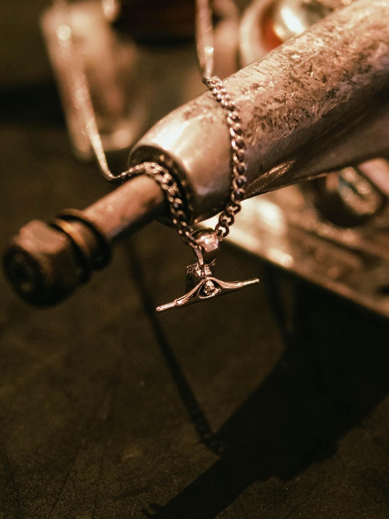 Sterling silver skateboard truck pendant on a Cuban chain, curated by Lucid Reality
