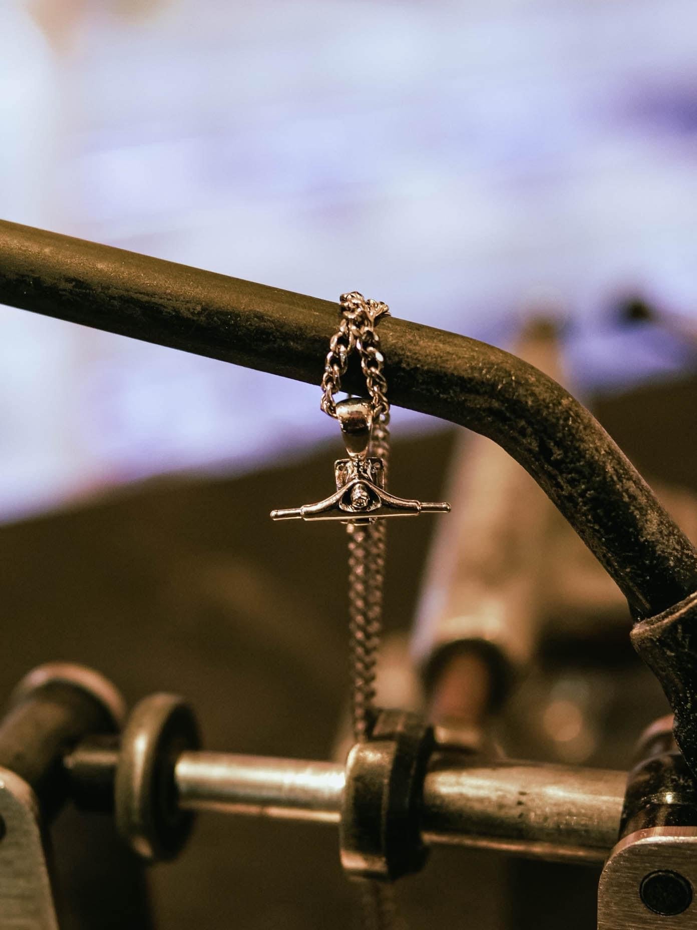 Sterling silver skateboard truck pendant on a Cuban chain, curated by Lucid Reality