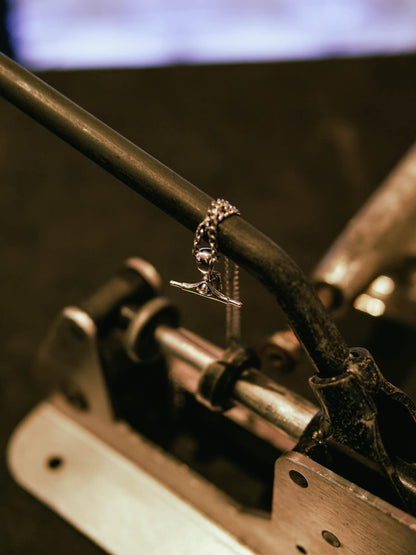 Sterling silver skateboard truck pendant on a Cuban chain, curated by Lucid Reality