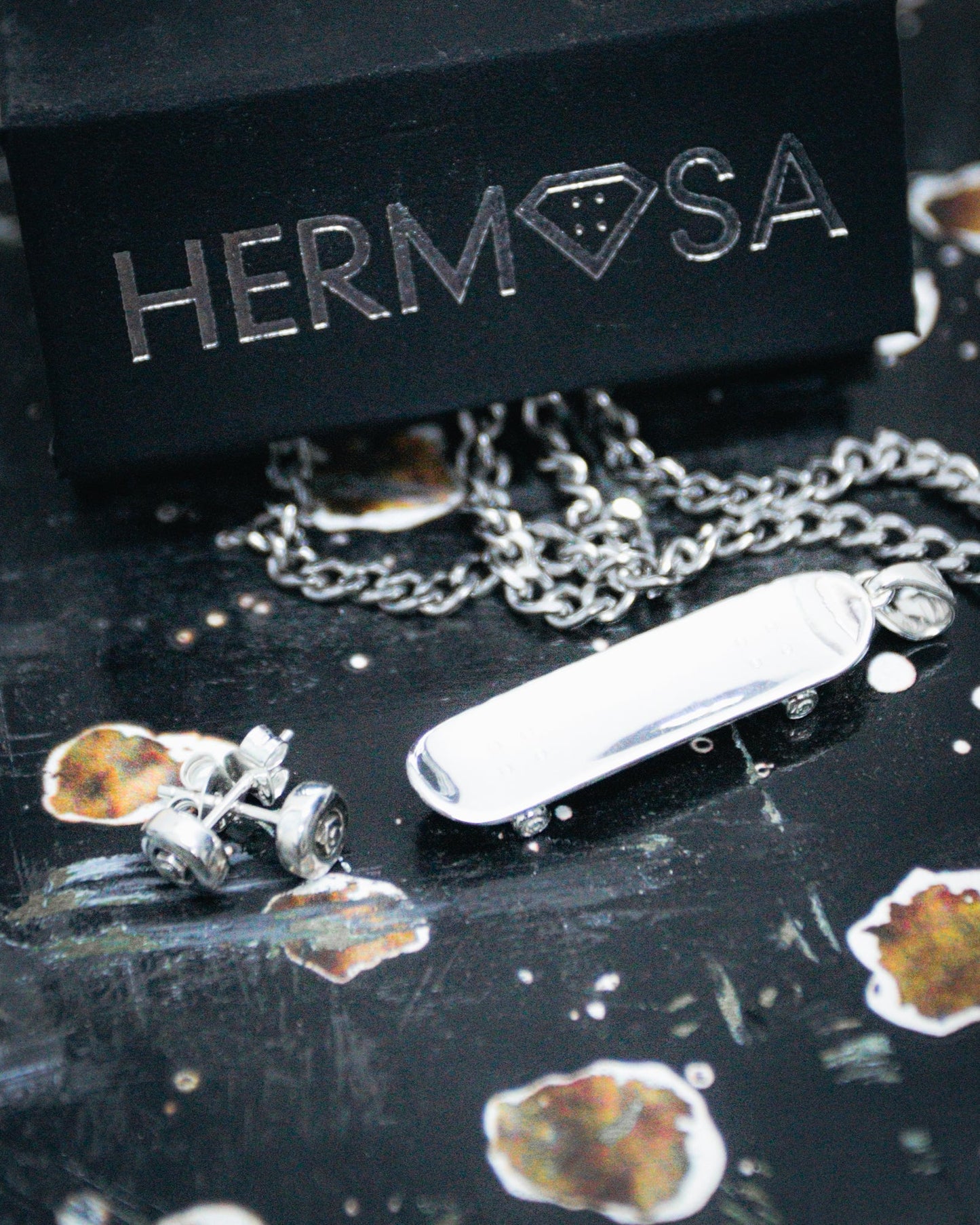 Sterling silver skateboard deck pendant with wheel stud earrings, curated by Lucid Reality