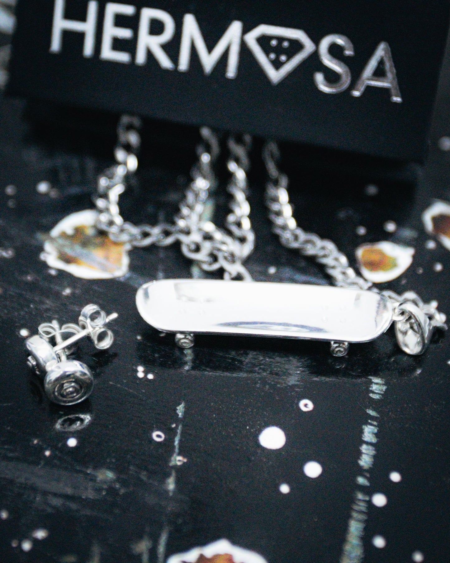 Sterling silver skateboard deck pendant with wheel stud earrings, curated by Lucid Reality