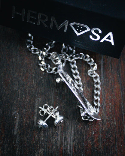 Sterling silver skateboard deck pendant with wheel stud earrings, curated by Lucid Reality