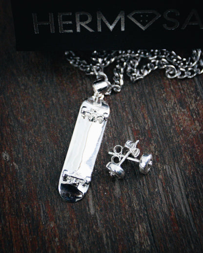 Sterling silver skateboard deck pendant with wheel stud earrings, curated by Lucid Reality