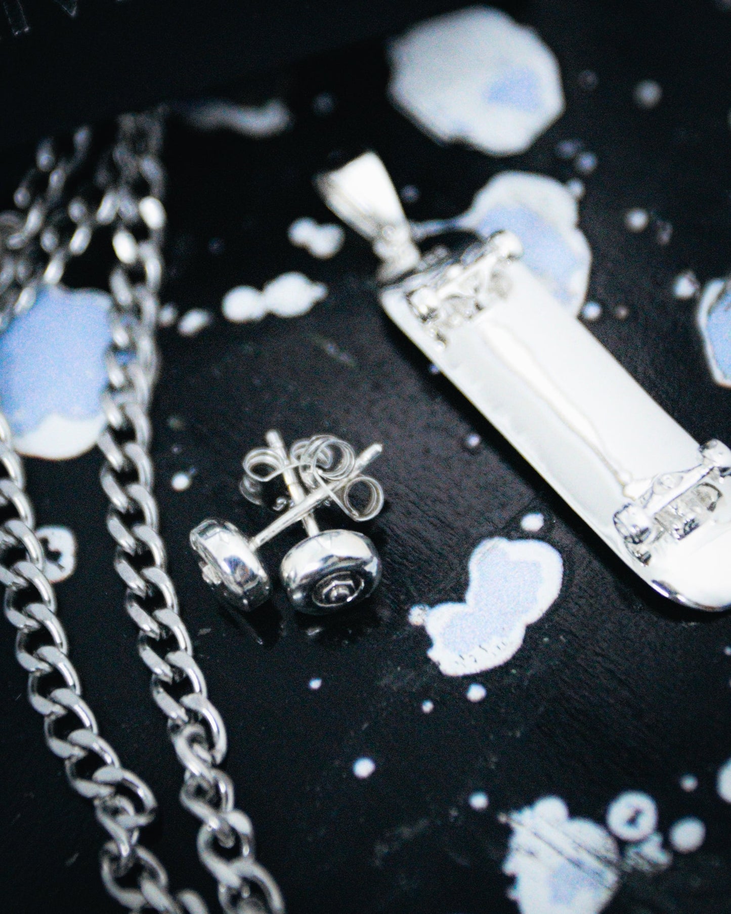 Sterling silver skateboard deck pendant with wheel stud earrings, curated by Lucid Reality