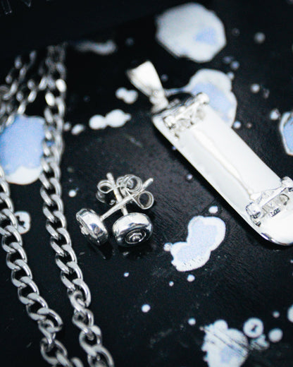 Sterling silver skateboard deck pendant with wheel stud earrings, curated by Lucid Reality
