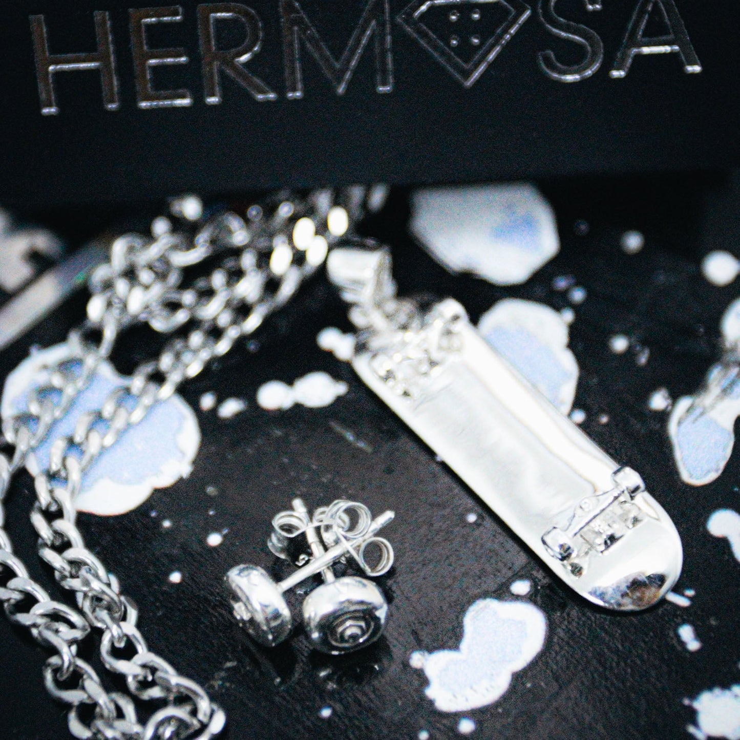 Sterling silver skateboard deck pendant with wheel stud earrings, curated by Lucid Reality