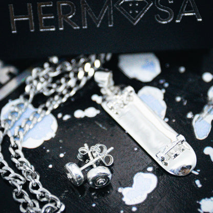 Sterling silver skateboard deck pendant with wheel stud earrings, curated by Lucid Reality
