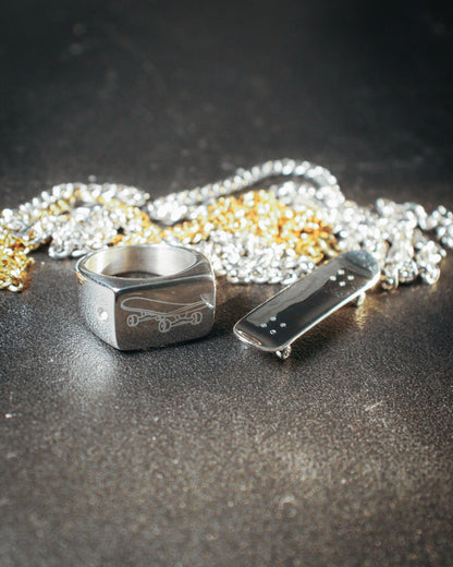 Sterling silver skateboard deck pendant with matching ring, curated by Lucid Reality