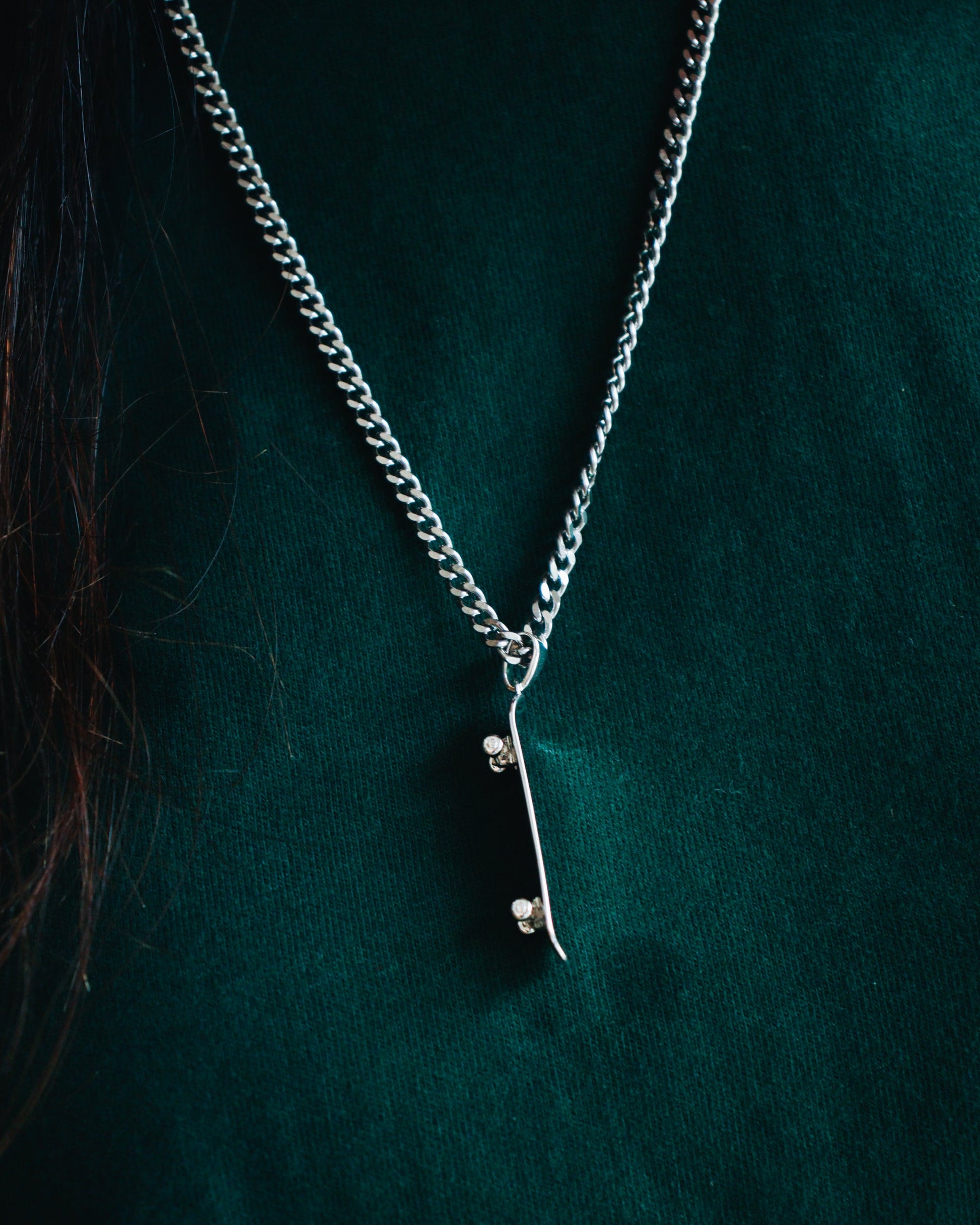 Sterling silver skateboard deck pendant with matching ring, curated by Lucid Reality