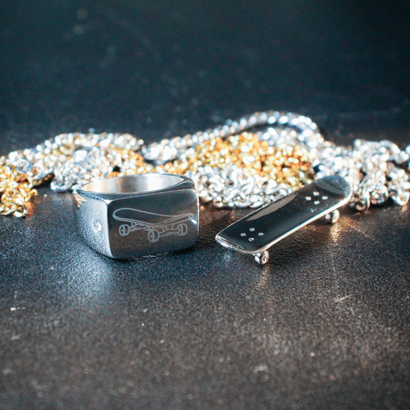 Sterling silver skateboard deck pendant with matching ring, curated by Lucid Reality