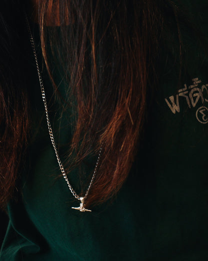 Sterling silver skateboard truck pendant on a Cuban chain, curated by Lucid Reality