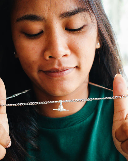 Sterling silver skateboard truck pendant on a Cuban chain, curated by Lucid Reality