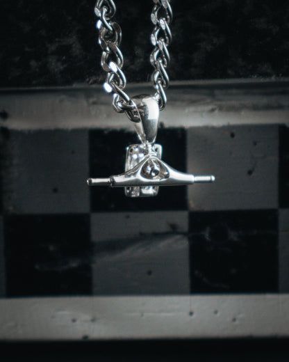 Sterling silver skateboard truck pendant on a Cuban chain, curated by Lucid Reality