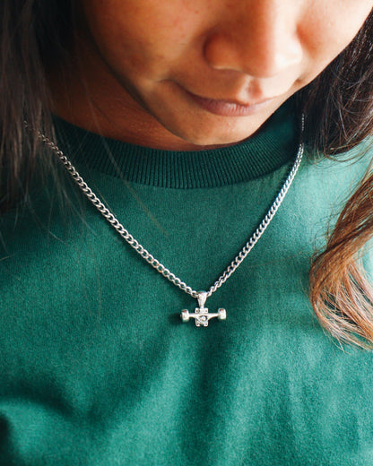 Sterling silver skateboard truck with wheels pendant on a Cuban chain, curated by Lucid Reality