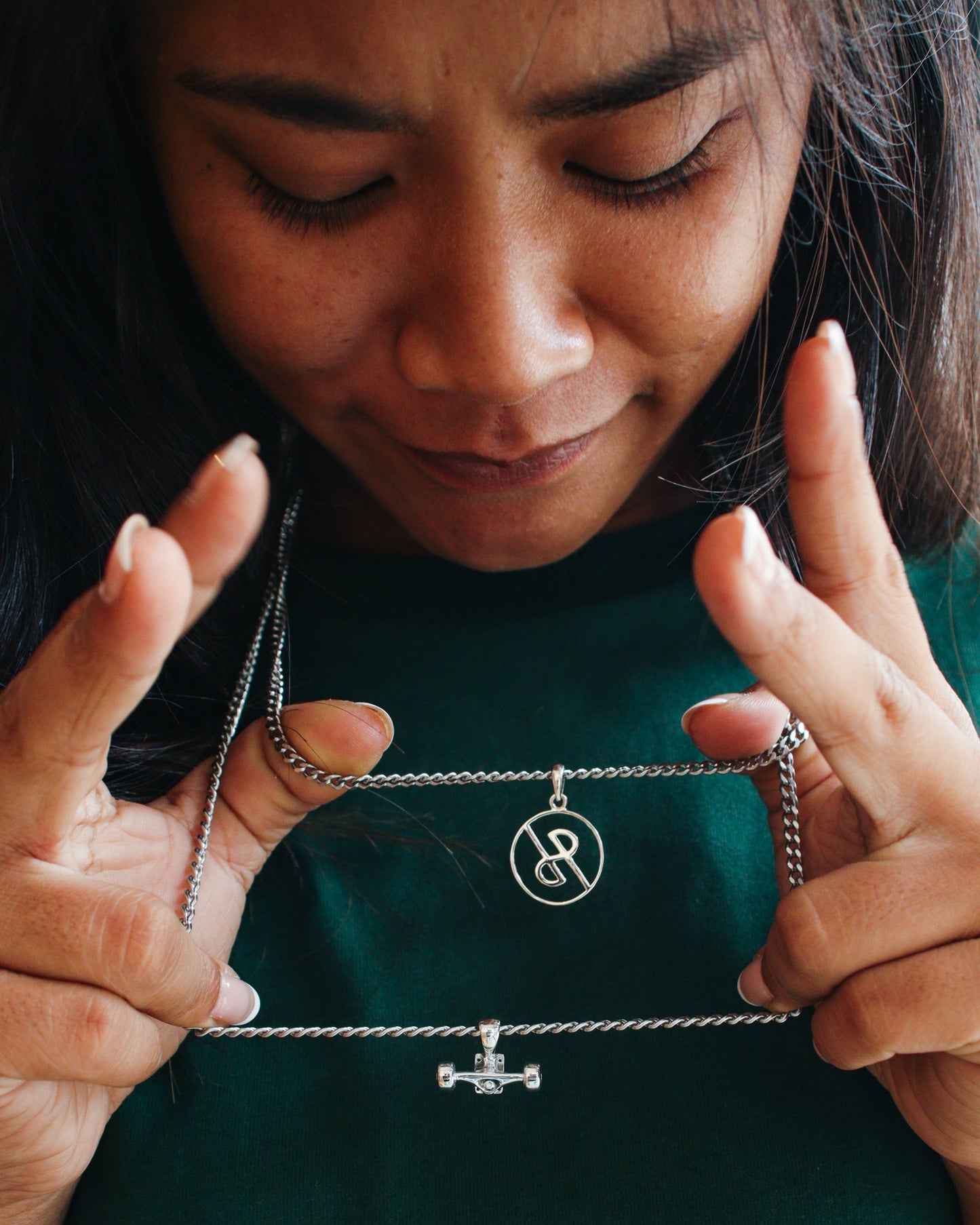Sterling silver skateboard truck with wheels pendant on a Cuban chain, curated by Lucid Reality