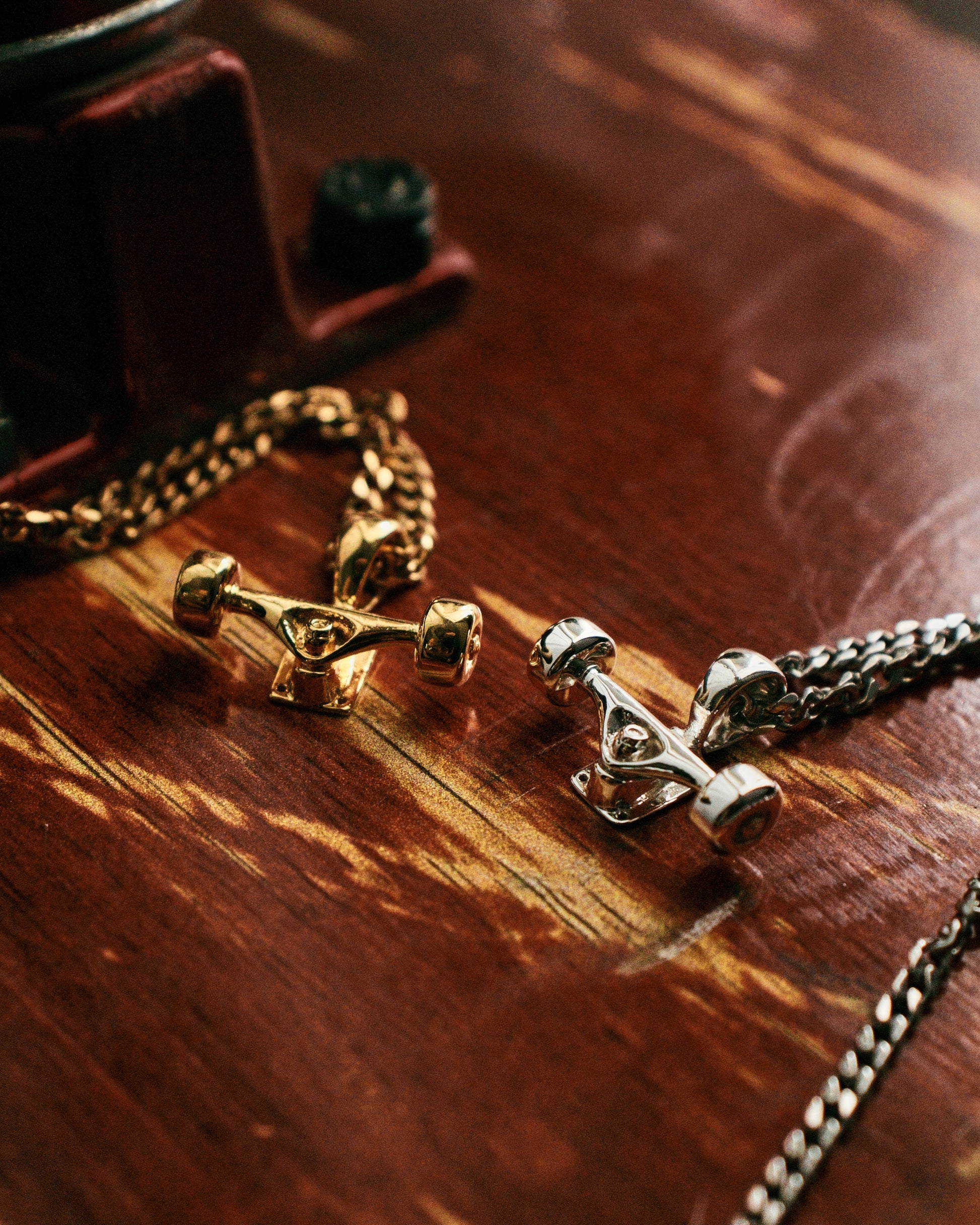 Sterling silver skateboard truck with wheels pendant on a Cuban chain, curated by Lucid Reality